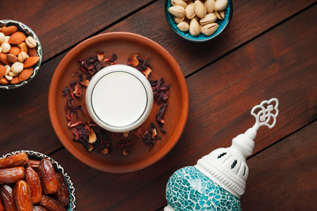 Ramadan Kareem and iftar muslim food. Pitted dates, nuts and milk on wooden boards. traditional iftar foodの写真素材