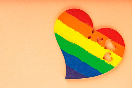 Rainbow heart on coral background. LGBT equal rights movement and gender equality concept. top view. copy spaceの写真素材
