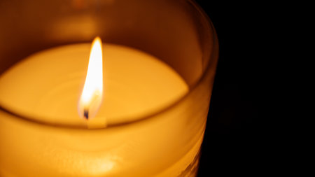 Close-up of Burning Candle on Dark Background, Concept of Inner Peaceの写真素材