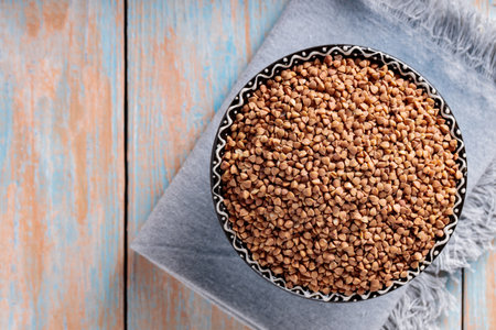 Buckwheat Grains in Bowl on Wooden Background, Healthy and Diet Food Concept, Top View, Copy Spaceの写真素材