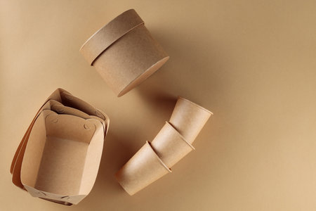 Cardboard Disposable Cups, Containers and Boxes on Beige Background, Zero Waste Concept, Copy Spaceの写真素材