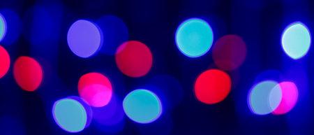 Vibrant Multi-Colored Bokeh Lights Creating Abstract Nightlife Background with Defocused Circular Patternsの写真素材