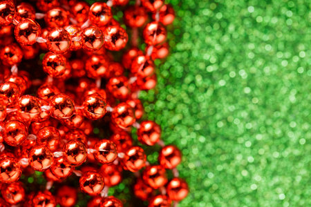 Red Sparkling Beads on Green Glitter Background, Christmas and New Year Decorations, Copy Spaceの写真素材