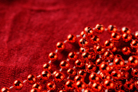 Red Sparkling Beads on Red Fabric Background, Christmas and New Year Decorations, Copy Spaceの写真素材