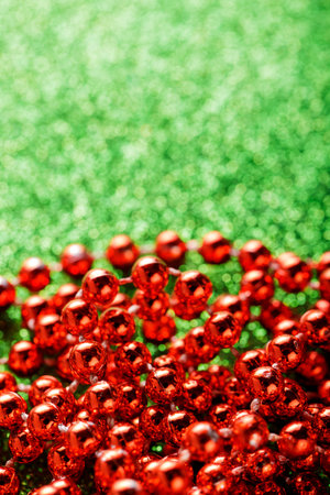 Red Beads on Sparkling Green Background for Cheerful Christmas Decoration Concept, Copy Spaceの写真素材