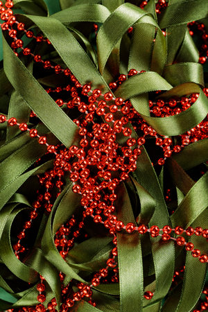 Red Beads on Green Festive Ribbon, Christmas and New Year Decorations Conceptの写真素材