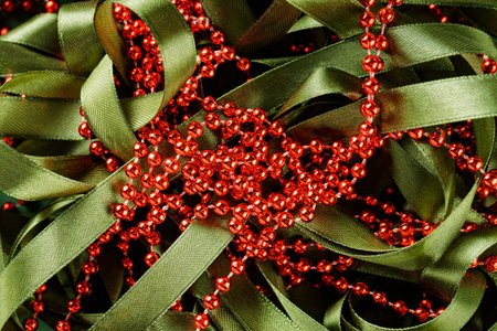 Red Beads on Green Festive Ribbon, Christmas and New Year Decorations Concept