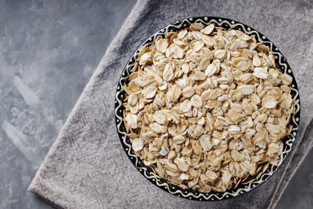 Raw Rolled Oats on Gray Background, Healthy Eating Concept, Copy Space, Top View