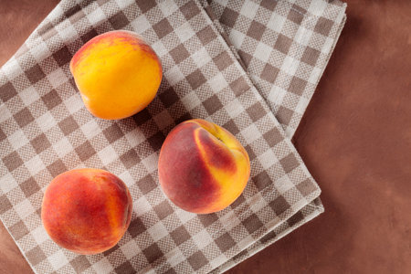 Fresh Peaches on Beige Checkered Napkin, Copy Space