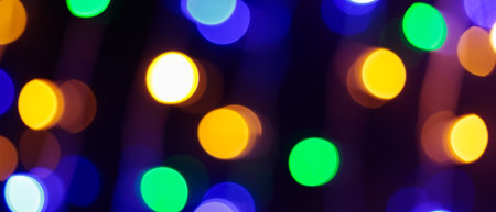 Multicolored Bokeh Background with Blurred Yellow Green Blue Orange Circles on Dark Background