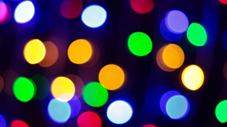 Multicolored Bokeh Background with Blurred Yellow Green Blue Orange Circles on Dark Backgroundの写真素材