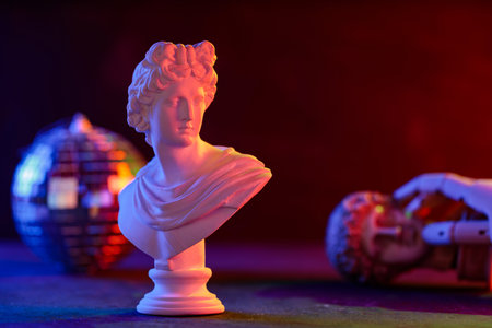 Classical Sculpture Bust Cradled in Mannequin Hand Neon Disco Ballの写真素材