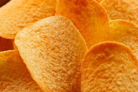 Close-Up of Golden Potato Chips with Oily Texture and Flavor