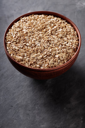 Grain Porridge in Rustic Bowl on Concrete Surface