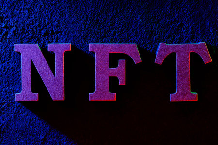 NFT Letters on Textured Wall with Neon Blue and Red Lightingの写真素材
