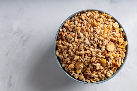Homemade Crunchy Granola with Oats and Nuts on Concrete Surface Top View Copy Space