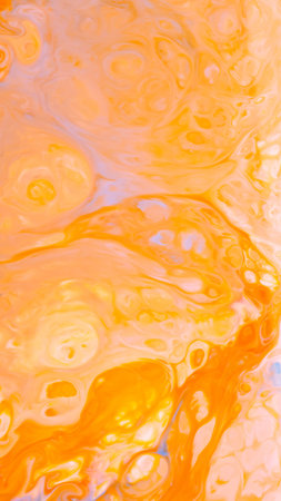 Golden Orange Paint Swirl in Vibrant Liquid Abstract Compositionの写真素材