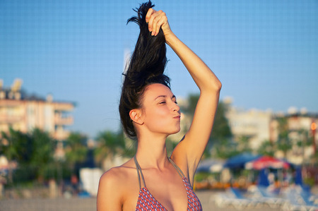 Young girl holding his hair, a grimace on his face, mouth bow