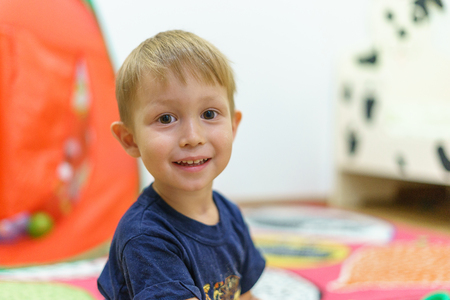 Little boy sitting in the children's room, home. Portrait of a child three years.の写真素材