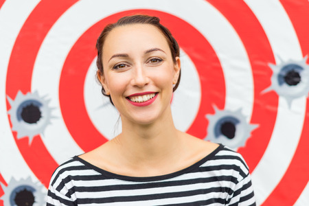 Woman laughing and showing his smile, target red striped on white background. Cheerful mood and smile on face, Laughter and joy, of women's innocence.の写真素材