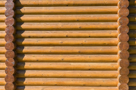 The log walls of the house. Wooden wall texture