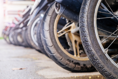 Wheels from bikes. Parking of motorcycles. Moped Tiresの写真素材