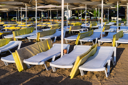 Empty chaise lounge on the beach. Urban beach in the early morning. Beach without peopleのeditorial素材