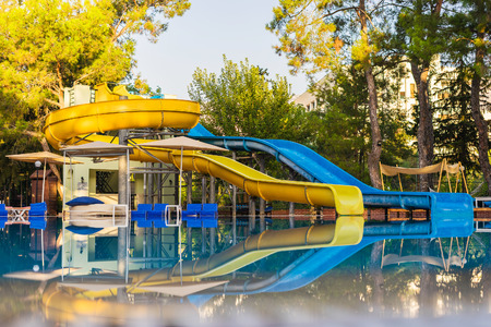Water slides by the pool. Empty pool with water slides in the park.のeditorial素材