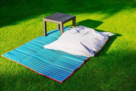 Pillow and coffee table on the grass. Rest area on the lawn.の写真素材