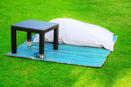 Pillow and coffee table on the grass. Rest area on the lawn.の写真素材