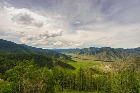 Mountain valley with the road below. Mountain landscape from a height. Altai