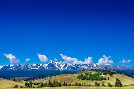 Snow ridge and valley. Snow-capped mountains in summer