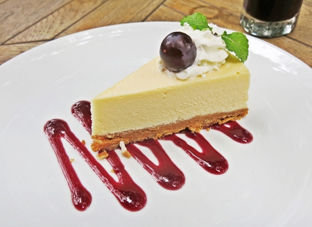 grape cheese cake with sweet grape sauce on white plateの写真素材