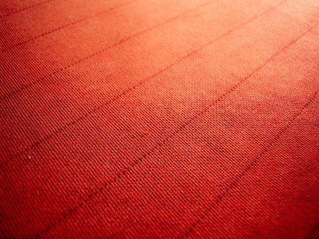 Orange-red background with fabric texture and line striped patternの写真素材