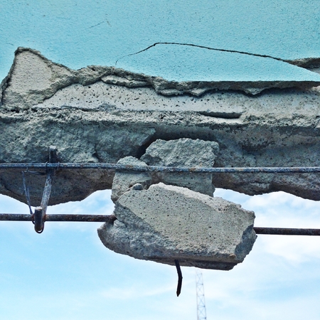 old wall with pieces of destroyed cement concreteの写真素材