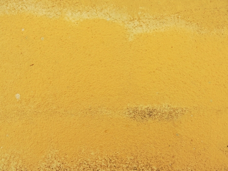 old yellow cement concrete wall backgroundの写真素材