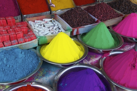 Colorful piles of Indian bindi powder dye at outdoor market in India blue, yellow, green, pink, and purpleの写真素材