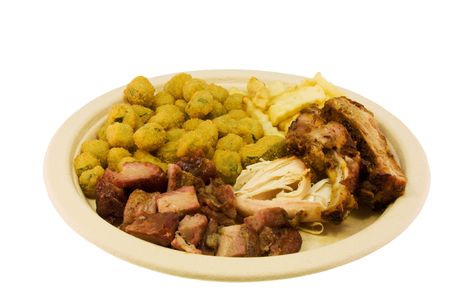 picnic style bbq plate with ribs, sliced port, pulled chicken, fries, and fried okraの写真素材