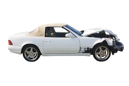 white luxury convertible with front end damage isolated on whiteの写真素材