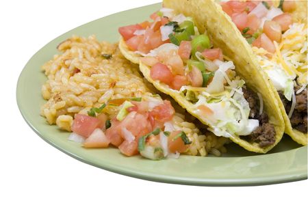 closeup of three crunchy tacos with rice on a green plate on whiteの写真素材