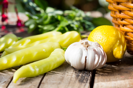 Fresh chili, garlic and lemon on wooden old tableの写真素材