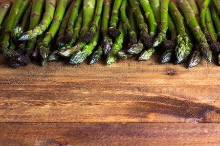fresh green asparagus on dark wooden table. background horizontalの写真素材