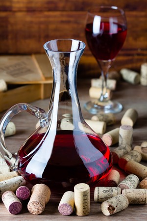 Background with glass of wine, decanter and wine corcs. Wine conceptの写真素材
