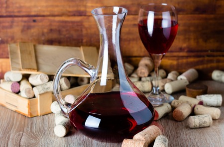 Background with glass of wine, decanter and wine corcs. Wine conceptの写真素材