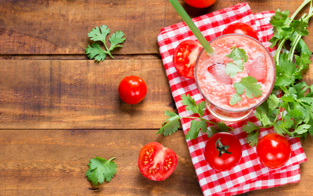 Tomato smoothie, fresh tomatoes and cilantro on wooden dark background. Top viewの写真素材