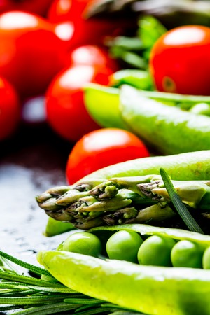 Close up of fresh vegetables - asparagus, tomatoes cherry, rosemary, green pea, bell pepper. Selective focusの写真素材