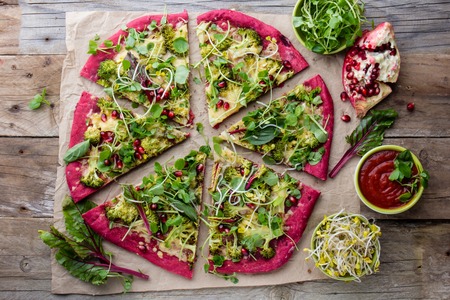 Purple beetroot dough, vegetables and sprouis pizza, Healthy fast food on slateの写真素材