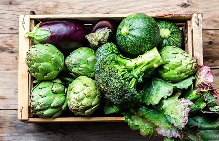 Cooking background harvest concept. Fresh organic green vegetables in wooden boxの写真素材