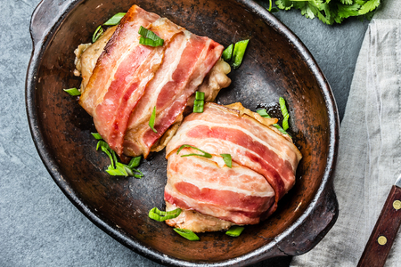 Chicken wrapped in bacon. Top view. Slate backgroundの写真素材