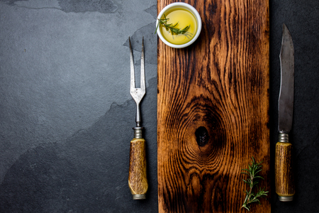 Cooking background concept. Vintage cutting board, cutlery and spices. Top viewの写真素材